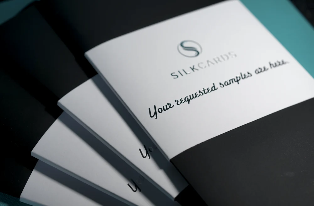 The SilkCards free sample kit — a stack of finished business-card samples across a range of premium stocks and finishes.