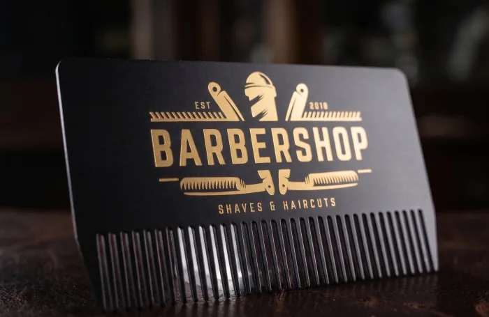 Black die-cut metal comb-shaped card for a barbershop